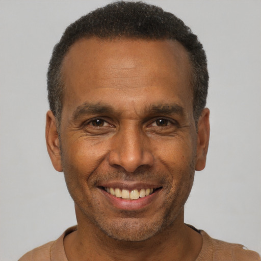 Joyful black adult male with short  black hair and brown eyes