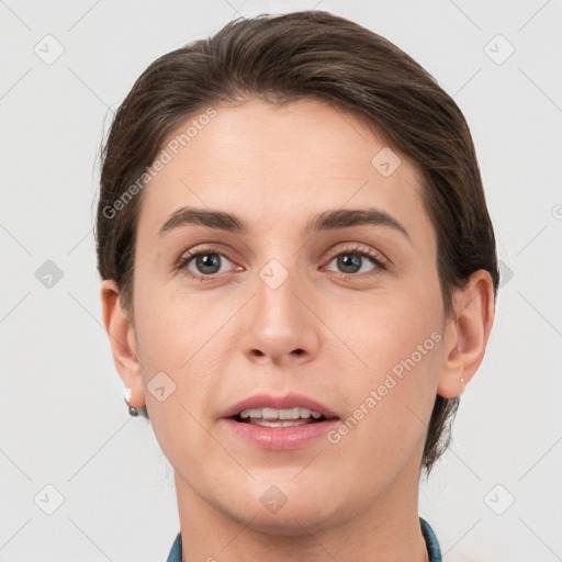 Joyful white young-adult female with short  brown hair and grey eyes