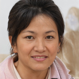 Joyful white adult female with medium  brown hair and brown eyes