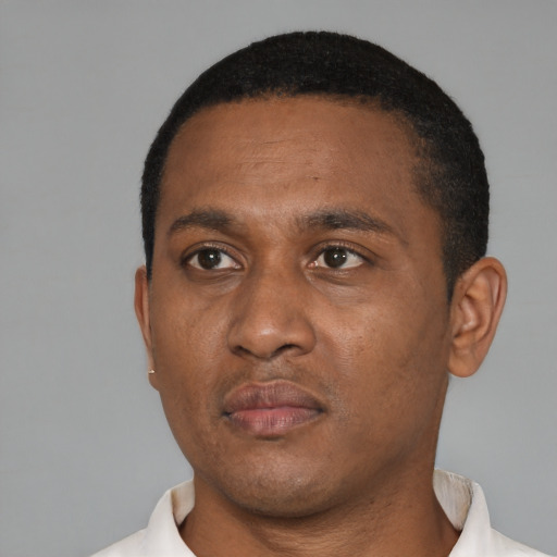 Neutral black adult male with short  black hair and brown eyes