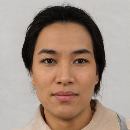 Joyful asian young-adult female with medium  black hair and brown eyes