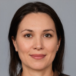 Joyful white adult female with medium  brown hair and brown eyes