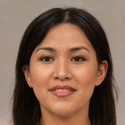 Joyful white young-adult female with long  brown hair and brown eyes