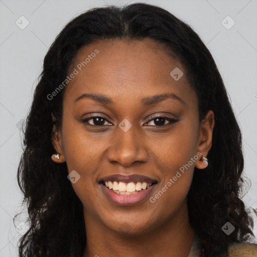 Joyful black young-adult female with long  brown hair and brown eyes