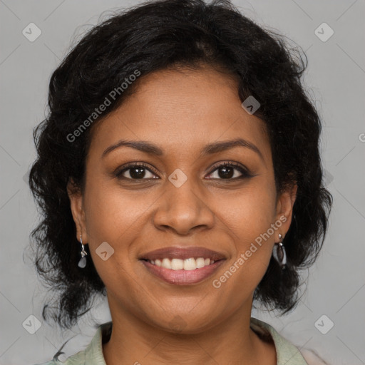 Joyful black adult female with medium  brown hair and brown eyes