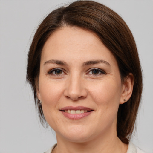 Joyful white adult female with medium  brown hair and brown eyes