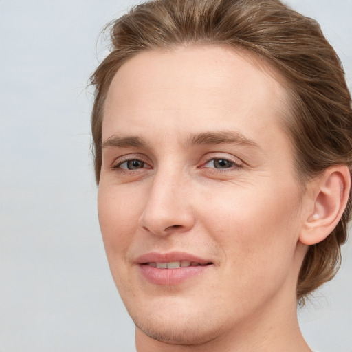 Joyful white young-adult female with medium  brown hair and blue eyes