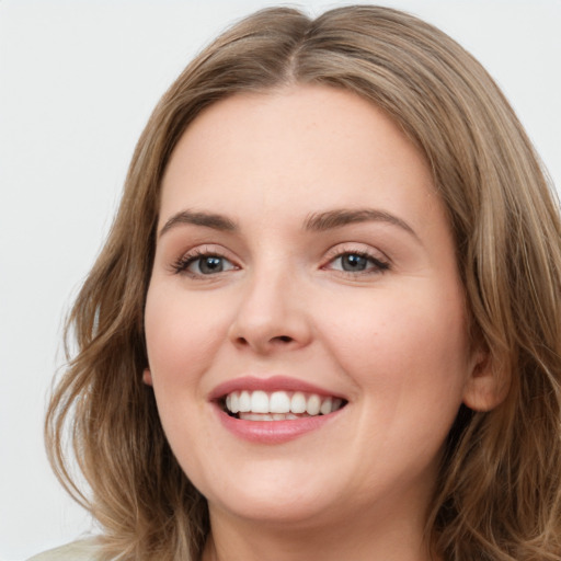 Joyful white young-adult female with long  brown hair and green eyes