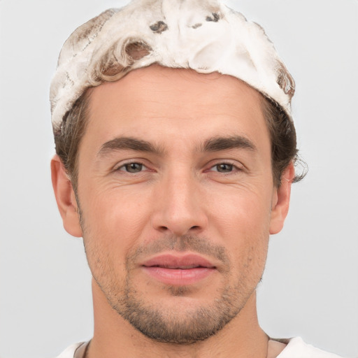 Joyful white adult male with short  brown hair and brown eyes