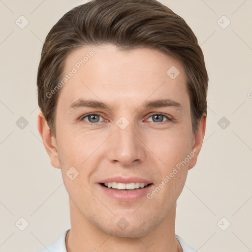 Joyful white young-adult male with short  brown hair and grey eyes