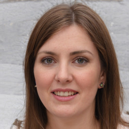 Joyful white young-adult female with long  brown hair and green eyes