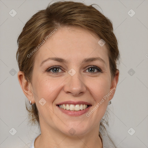 Joyful white adult female with medium  brown hair and grey eyes