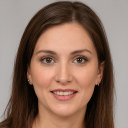 Joyful white young-adult female with long  brown hair and brown eyes