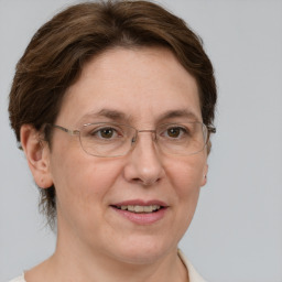 Joyful white adult female with short  brown hair and grey eyes