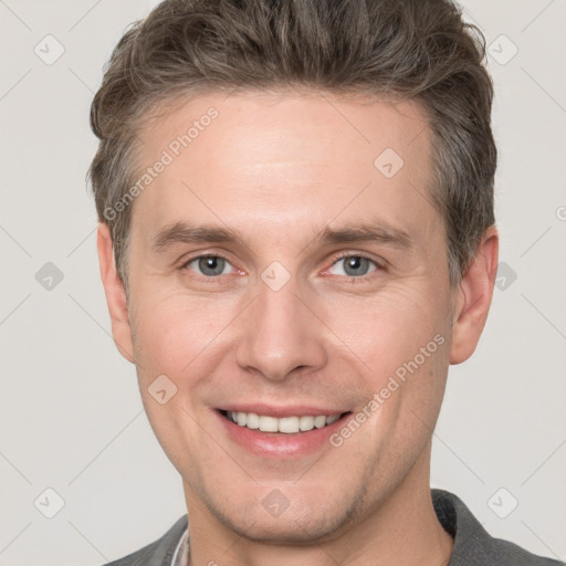 Joyful white adult male with short  brown hair and grey eyes