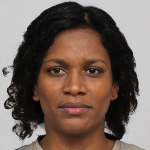 Joyful black young-adult female with medium  black hair and brown eyes