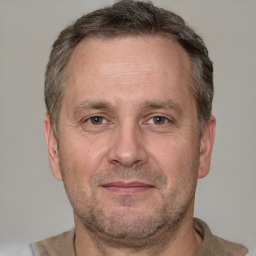 Joyful white adult male with short  brown hair and grey eyes