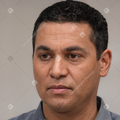 Joyful white adult male with short  black hair and brown eyes