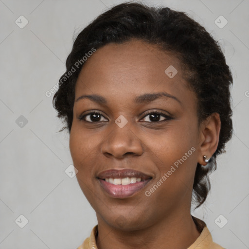 Joyful black young-adult female with short  brown hair and brown eyes