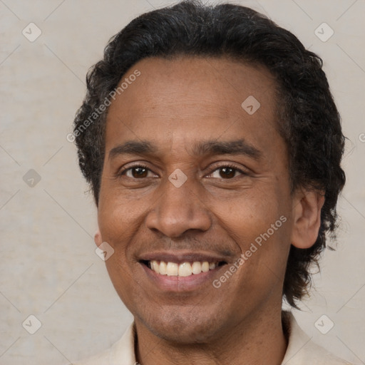 Joyful latino adult male with short  brown hair and brown eyes