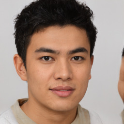 Joyful asian young-adult male with short  brown hair and brown eyes