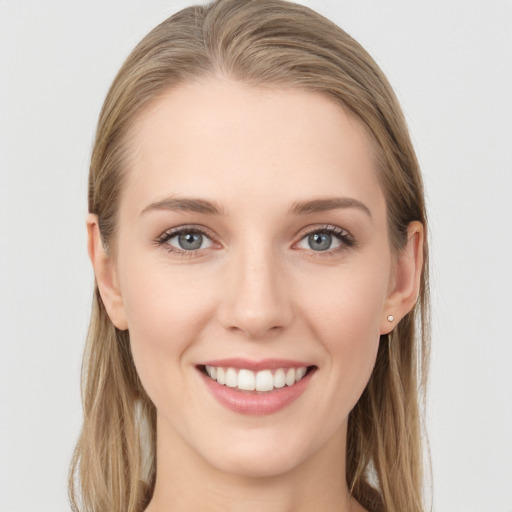 Joyful white young-adult female with long  brown hair and grey eyes