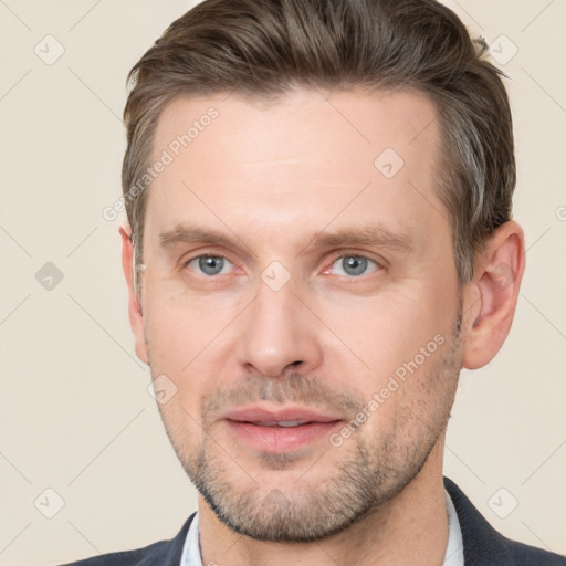 Joyful white adult male with short  brown hair and grey eyes