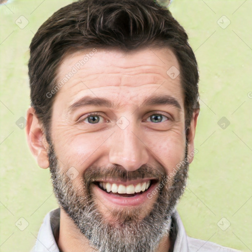 Joyful white adult male with short  black hair and brown eyes