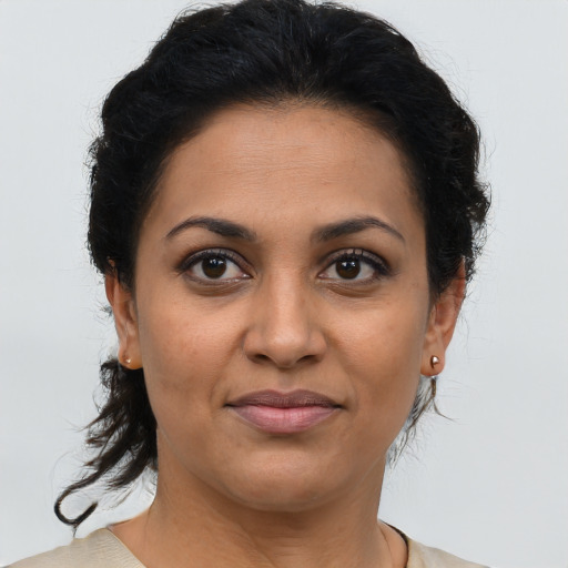 Joyful latino young-adult female with short  brown hair and brown eyes