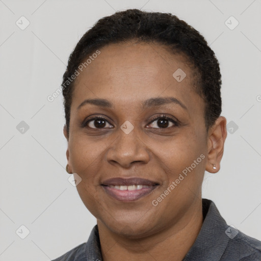 Joyful black adult female with short  black hair and brown eyes