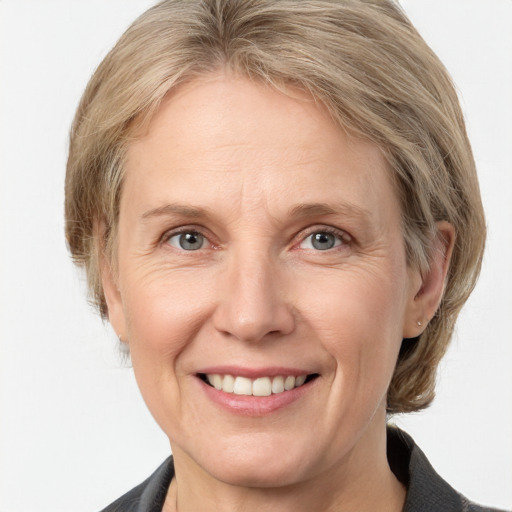 Joyful white adult female with medium  brown hair and grey eyes