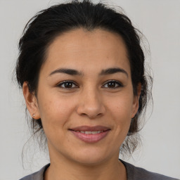 Joyful latino young-adult female with medium  brown hair and brown eyes