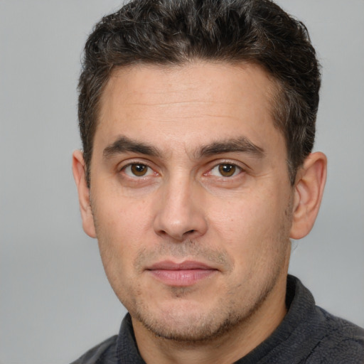 Joyful white adult male with short  brown hair and brown eyes