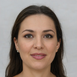 Joyful white young-adult female with long  brown hair and grey eyes