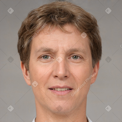 Joyful white adult male with short  brown hair and grey eyes