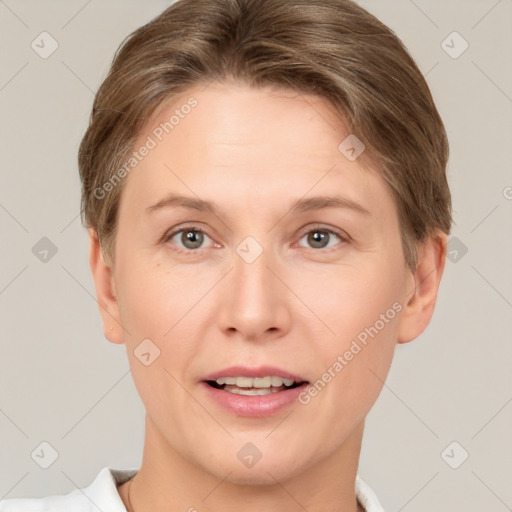 Joyful white young-adult female with short  brown hair and grey eyes