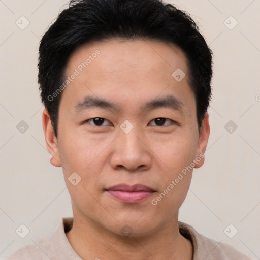 Joyful asian young-adult male with short  black hair and brown eyes