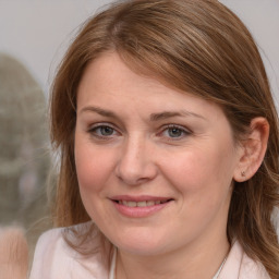 Joyful white young-adult female with medium  brown hair and blue eyes