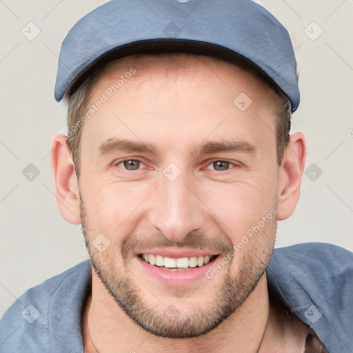 Joyful white young-adult male with short  brown hair and grey eyes