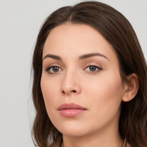 Neutral white young-adult female with long  brown hair and brown eyes