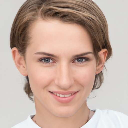 Joyful white young-adult female with short  brown hair and grey eyes