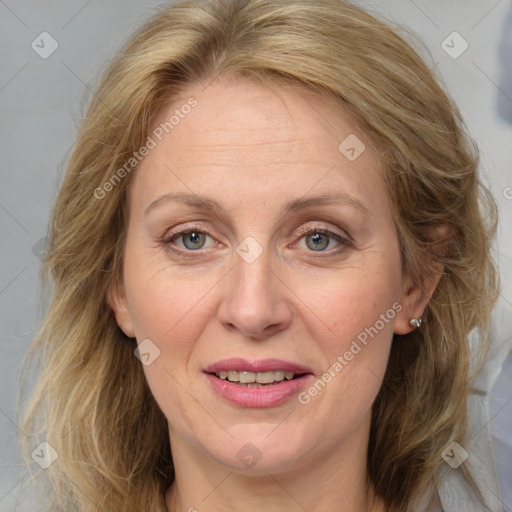 Joyful white adult female with medium  brown hair and blue eyes