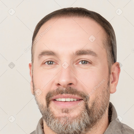 Joyful white adult male with short  brown hair and brown eyes