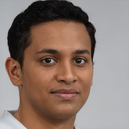 Joyful latino young-adult male with short  brown hair and brown eyes