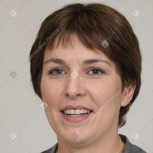 Joyful white adult female with medium  brown hair and grey eyes