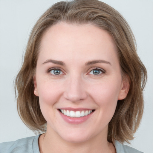 Joyful white young-adult female with medium  brown hair and blue eyes