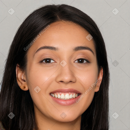 Joyful latino young-adult female with long  black hair and brown eyes