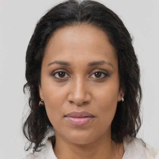 Joyful black young-adult female with medium  brown hair and brown eyes
