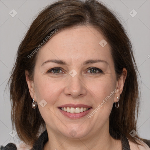 Joyful white adult female with medium  brown hair and grey eyes