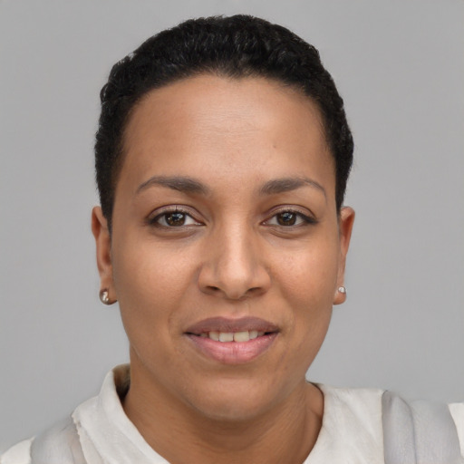 Joyful latino young-adult female with short  black hair and brown eyes